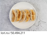 Gyoza beautifully arranged in a white plate. Стоковое фото, агентство Ingram Publishing / Фотобанк Лори