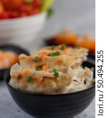 Gyoza in a black cup with Sushi. Selective focus. Стоковое фото, агентство Ingram Publishing / Фотобанк Лори