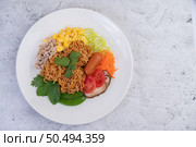 Stir-fried noodles with minced pork, edamame, tomatoes and mushrooms in a white plate. Стоковое фото, агентство Ingram Publishing / Фотобанк Лори