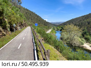 Point of view shot of riding a bicycle in Sever do Vouga, Portugal. Features a wide view of the bike track and the natural scenery. Стоковое фото, агентство Ingram Publishing / Фотобанк Лори