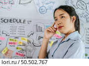 Young asian woman smiling and present planing of project on board in meeting room, copy space. Стоковое фото, агентство Ingram Publishing / Фотобанк Лори