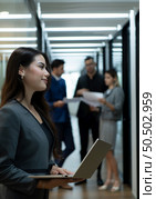 New business group person in the corridor of the conference room, Rehearse information to present results and new projects to the management team for consideration. Стоковое фото, агентство Ingram Publishing / Фотобанк Лори