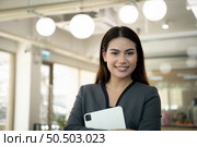 Portrait of Business female rookie in the new entrepreneurial with a tablet as a tool to help in the work. Стоковое фото, агентство Ingram Publishing / Фотобанк Лори