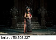 Young female Actress wearing beautiful ancient costumes, in ancient monuments, dramatic style. Perform on legend love popular story, Thai Isan folktale called "Phadaeng and Nang-ai" in acient site. Стоковое фото, агентство Ingram Publishing / Фотобанк Лори