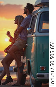 Vintage lens view, soft blurry focus on young stylish couple, travelers, friends watching colorful dreamy sunset, leaning on adventurous camper van. Стоковое AI-видео, аниматор Sergey Grishin / Фотобанк Лори