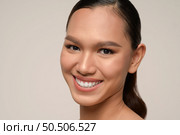 Close up, portrait of beautiful woman model with fresh daily make-up and toothy smile with beautiful face on gray background in studio, copy space. Стоковое фото, агентство Ingram Publishing / Фотобанк Лори