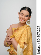 Close up, Portrait beautiful Asian woman in traditional Thai dress costume smile and pose gracefully on white background. Стоковое фото, агентство Ingram Publishing / Фотобанк Лори