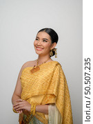 Close up, Portrait beautiful Asian woman in traditional Thai dress costume smile and pose gracefully on white background. Стоковое фото, агентство Ingram Publishing / Фотобанк Лори