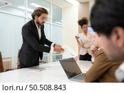 Group of young businessmen in international companies, Meeting to conclude a new responsible project. Стоковое фото, агентство Ingram Publishing / Фотобанк Лори