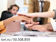 Businesspeople can motivate each other by joining hands. Стоковое фото, агентство Ingram Publishing / Фотобанк Лори
