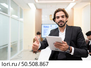 Portrait of young entrepreneurs are enthusiastically taking their ideas and sharing perspectives. In the meeting room of an international business corporation, Стоковое фото, агентство Ingram Publishing / Фотобанк Лори