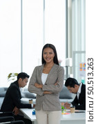 Portrait of an Asian female rookie in the new entrepreneurial team in the business of investment services. Стоковое фото, агентство Ingram Publishing / Фотобанк Лори