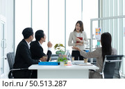 Young asian woman freshmen in the new generation of entrepreneurs team. Successfully presented the project to the satisfaction of the management. Стоковое фото, агентство Ingram Publishing / Фотобанк Лори