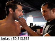 The boxer must wear a tooth collar before the fight to prevent the risk of injury from teeth clashing when punched in the chin or face, Muay Thai, Thai martial arts. Стоковое фото, агентство Ingram Publishing / Фотобанк Лори