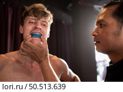 The boxer must wear a tooth collar before the fight to prevent the risk of injury from teeth clashing when punched in the chin or face, Muay Thai, Thai martial arts. Стоковое фото, агентство Ingram Publishing / Фотобанк Лори