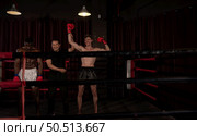 Victorious boxer the referee will raise their hands on stage, Muay Thai, Thai martial arts. Стоковое фото, агентство Ingram Publishing / Фотобанк Лори