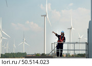 Engineer at Natural Energy Wind Turbine site with a mission to climb up to the wind turbine blades to inspect the operation of large wind turbines that converts wind energy into electrical energy. Стоковое фото, агентство Ingram Publishing / Фотобанк Лори
