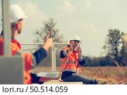 Engineer working at a wind farm for renewable energy has the responsibility of maintaining a sizable wind turbine. Encourage one another as you complete duties. Стоковое фото, агентство Ingram Publishing / Фотобанк Лори