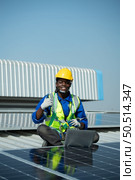Engineer in charge of solar panel installation The installation of solar energy conversion into electricity for a warehouse is currently being investigated. Стоковое фото, агентство Ingram Publishing / Фотобанк Лори