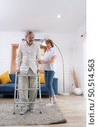 Old couple with her husband, who had to learn to walk after being treated for an osteoarthritis. Must help and take care of each other without children to take care of. Стоковое фото, агентство Ingram Publishing / Фотобанк Лори