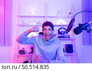 The winning mood of a professional gamer That is where the cash and celebrity come from. Стоковое фото, агентство Ingram Publishing / Фотобанк Лори