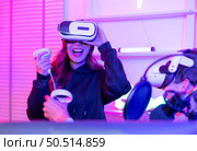 Two professional gamer playing games through VR machine that responds to very fun exciting and provocative. Стоковое фото, агентство Ingram Publishing / Фотобанк Лори
