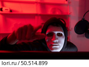 This is the face of a hacker who is knowledgeable with operating systems and other programs. He will exploit flaws and breach the computer system to cause damage. Стоковое фото, агентство Ingram Publishing / Фотобанк Лори