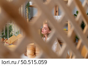 Young female runs a small business making clay jewelry. Presented to customers with products via an internet channel. Стоковое фото, агентство Ingram Publishing / Фотобанк Лори