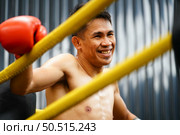 Muay Thai, The martial art of Thailand, Boxer sitting in the corner When the referee stops the fight in each round for the boxer to rest and the coach to introduce the fight in the next round. Стоковое фото, агентство Ingram Publishing / Фотобанк Лори