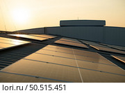 Solar farm on roof and sunset Solar modules for renewable energy technology that people have access to. Стоковое фото, агентство Ingram Publishing / Фотобанк Лори