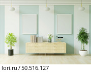 The living room is decorated with a storage table, picture frames and small plant pots. Стоковое фото, агентство Ingram Publishing / Фотобанк Лори