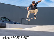 Skateboarder doing ollie trick on a urban scene. Стоковое фото, агентство Ingram Publishing / Фотобанк Лори
