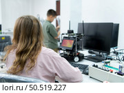 Youngsters utilizing the hand robot technology are having fun learning the electronic circuit board and hand robot controller of robot technology, which is one of the STEM courses. Стоковое фото, агентство Ingram Publishing / Фотобанк Лори