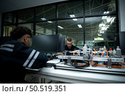 The robotic hand technology teacher is instructing new students on how to use electronic circuit boards and robotic hand commands for a variety of industrial applications. Стоковое фото, агентство Ingram Publishing / Фотобанк Лори