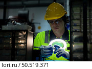The technician must use bright lights and a magnifying glass to check the detail of the workpiece. the 3D printer’s printout. Стоковое фото, агентство Ingram Publishing / Фотобанк Лори