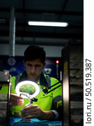 The technician must use bright lights and a magnifying glass to check the detail of the workpiece. the 3D printer’s printout. Стоковое фото, агентство Ingram Publishing / Фотобанк Лори