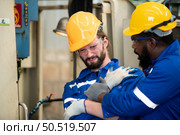 Working in a large industrial facility with heavy materials and machinery. Safety considerations are therefore of the utmost significance. Extreme vigilance must be exercised in this situation. Стоковое фото, агентство Ingram Publishing / Фотобанк Лори