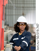 Portrait of a young female engineer in the welding robot industry, posed like a top model. Стоковое фото, агентство Ingram Publishing / Фотобанк Лори