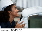 Portrait of a young female engineer in the welding robot industry, posed like a top model. Стоковое фото, агентство Ingram Publishing / Фотобанк Лори