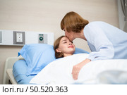 A mother blankets her child who is hospitalized. Show your love and concern with a kiss before bedtime. Стоковое фото, агентство Ingram Publishing / Фотобанк Лори