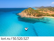 Aerial view of luxury yachts on blue sea at sunset in summer. Sardinia, Italy. Tropical seascape with speed boats, yachts, sea lagoon, mountain, transparent turquoise water, sky. Top drone view. Стоковое фото, агентство Ingram Publishing / Фотобанк Лори