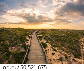 View from the walkway south of Furadouro beach in Ovar on a stormy day at sunset. Стоковое фото, агентство Ingram Publishing / Фотобанк Лори