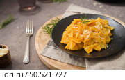 Farfalle pasta with pumpkin sauce in a ceramic plate on a dark stone kitchen counter top. Стоковое фото, агентство Ingram Publishing / Фотобанк Лори