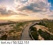 View from the walkway south of Furadouro beach in Ovar on a stormy day at sunset. Стоковое фото, агентство Ingram Publishing / Фотобанк Лори