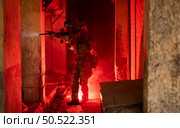 Soldier in anti-terrorist warfare in a dark building, Anti-terrorist operation training on the battlefield. Стоковое фото, агентство Ingram Publishing / Фотобанк Лори