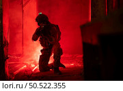 Soldier in anti-terrorist warfare in a dark building, Anti-terrorist operation training on the battlefield. Стоковое фото, агентство Ingram Publishing / Фотобанк Лори