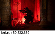 Soldier in anti-terrorist warfare in a dark building, Anti-terrorist operation training on the battlefield. Стоковое фото, агентство Ingram Publishing / Фотобанк Лори