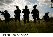 Soldier holding gun and showing action success or war win, special forces military training concept. Стоковое фото, агентство Ingram Publishing / Фотобанк Лори