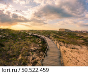 View from the walkway south of Furadouro beach in Ovar on a stormy day at sunset. Стоковое фото, агентство Ingram Publishing / Фотобанк Лори