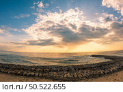 View of the seawall south of Furadouro beach in Ovar on a stormy day at sunset. Стоковое фото, агентство Ingram Publishing / Фотобанк Лори